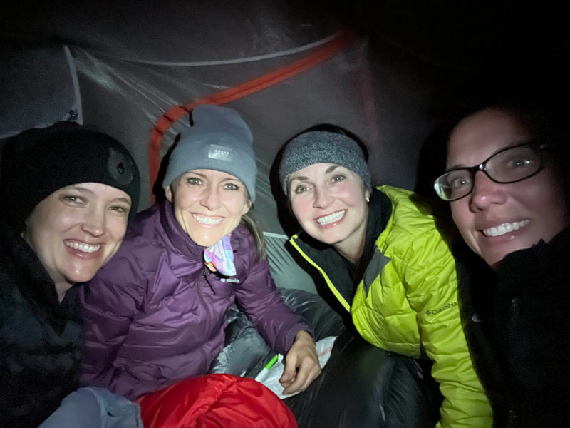 The women of WildPathsAZ in a tent at Charlebois Spring