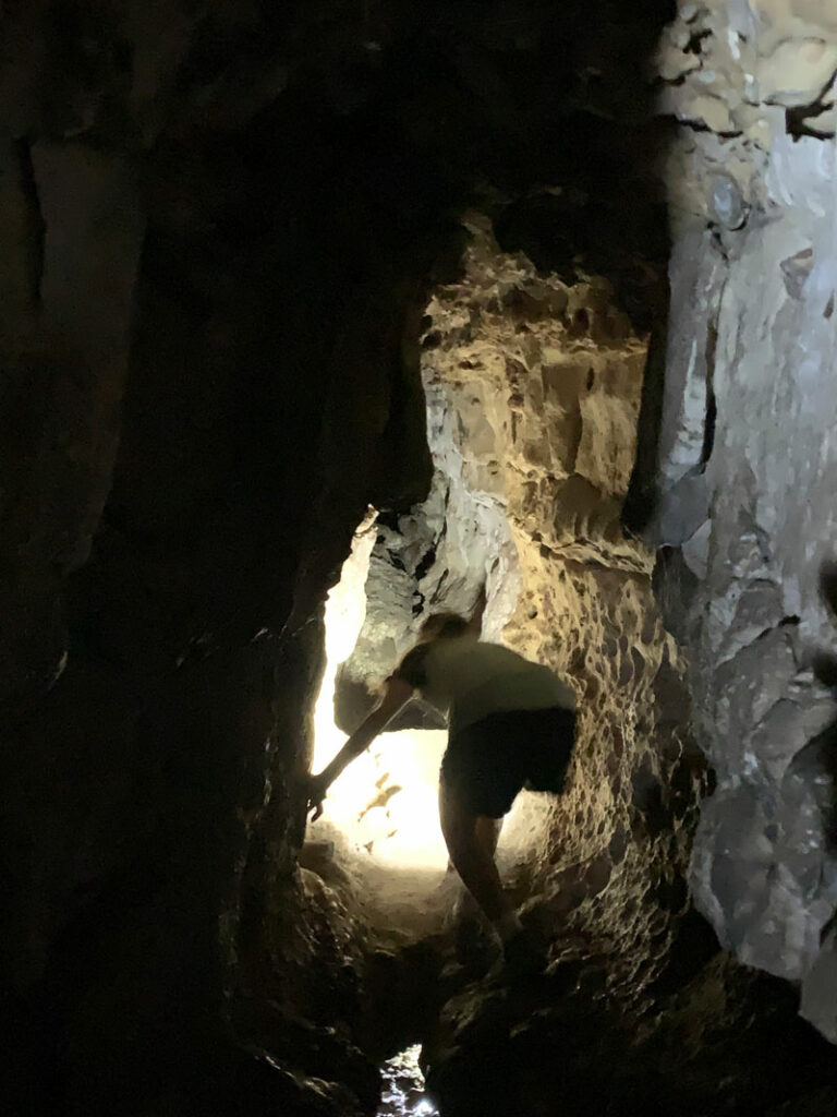 Exploring a passageway in Pivot Spring Cave