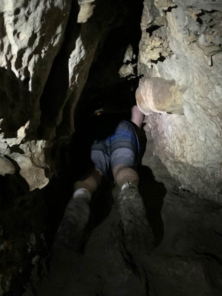 Belly sliding in Pivot Spring Cave
