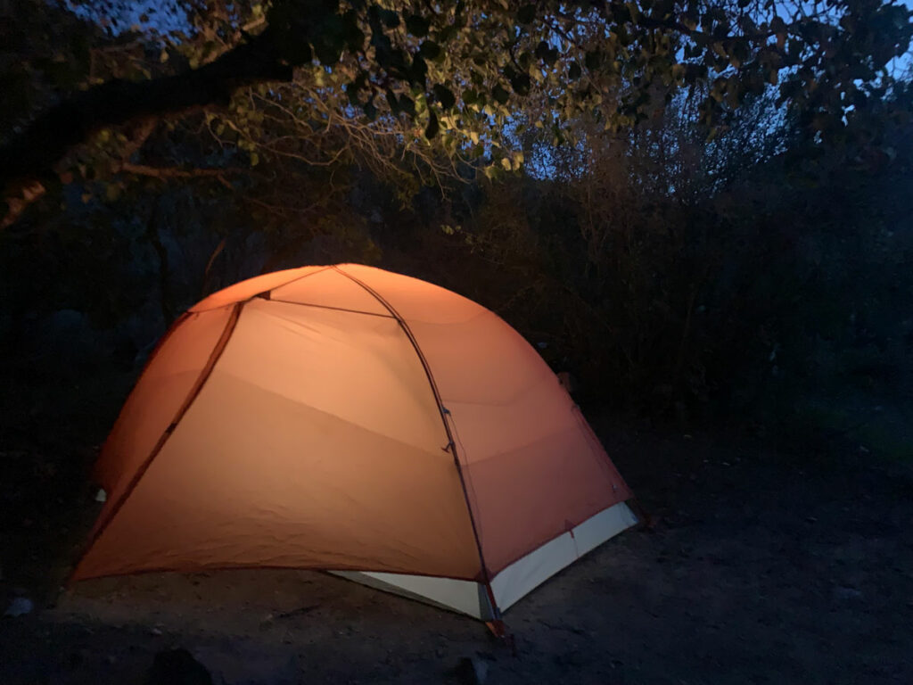 A tent at night in the wilderness